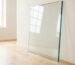 10mm clear float glass panel cut to size with polished edges, leaning against a white wall