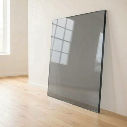 10mm grey tinted glass panel cut to size with polished edges, leaning against a white wall