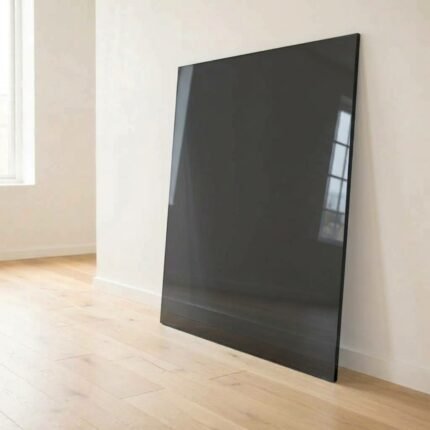 6mm super grey dark tinted glass panel cut to size with polished edges, leaning against a white wall