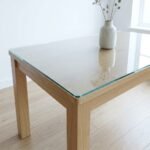 Clear toughened glass table top on an oak dining table