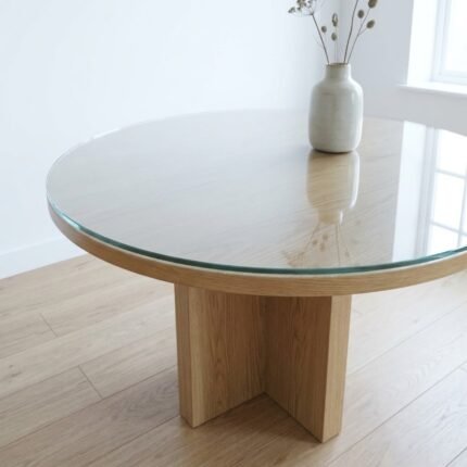 Round clear toughened glass table top on a round oak table